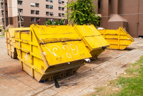 Residents disposing of furniture at Hackbridge recycling center